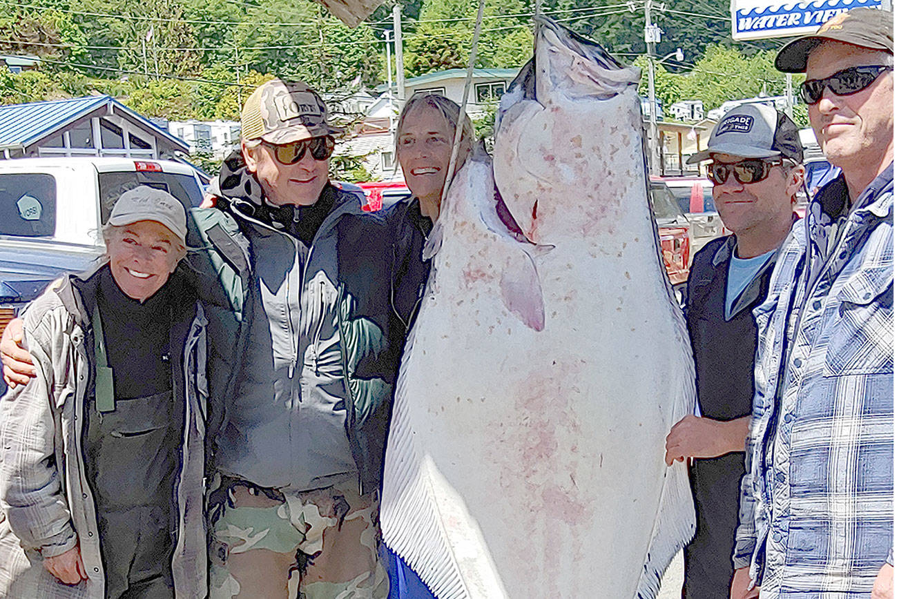 This 75-inch, 224-pound halibut was caught by Mike Mahoney of Park City, Utah, third from left, while fishing the Strait of Juan de Fuca out of Sekiu's Van Riper's Resort. The state record for Pacific halibut is a 288-pounder caught at Swiftsure Bank in September 1989.