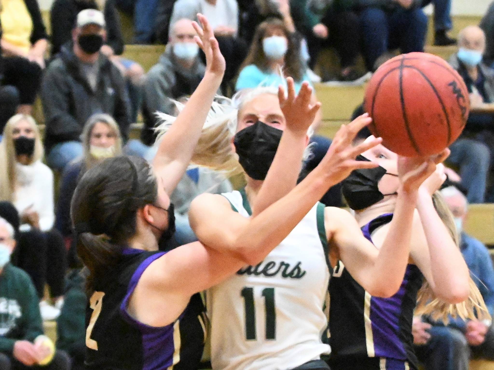 Michael Dashiell/Olympic Peninsula News Group
Port Angeles' Millie Long is defended by Sequim's Hannah Bates (2) and Jolene Vaara. Port Angeles won 68-52 to win the Olympic League Tournament and finish a perfect season at 15-0.