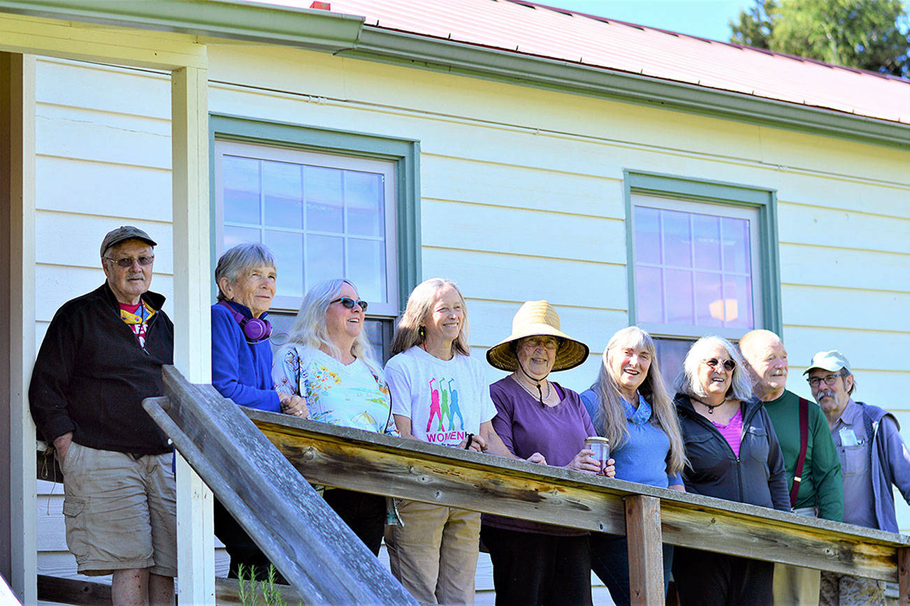 Celebrating the reopening of the Quimper Grange this Saturday are, from left, George and Jo Yount, Susan Stone, Barbara Tusting, Kathy Ryan, Sheila Long, Mary Beth Haralovich, Doug Groenig and J.J. Johnson. (Diane Urbani de la Paz/Peninsula Daily News)