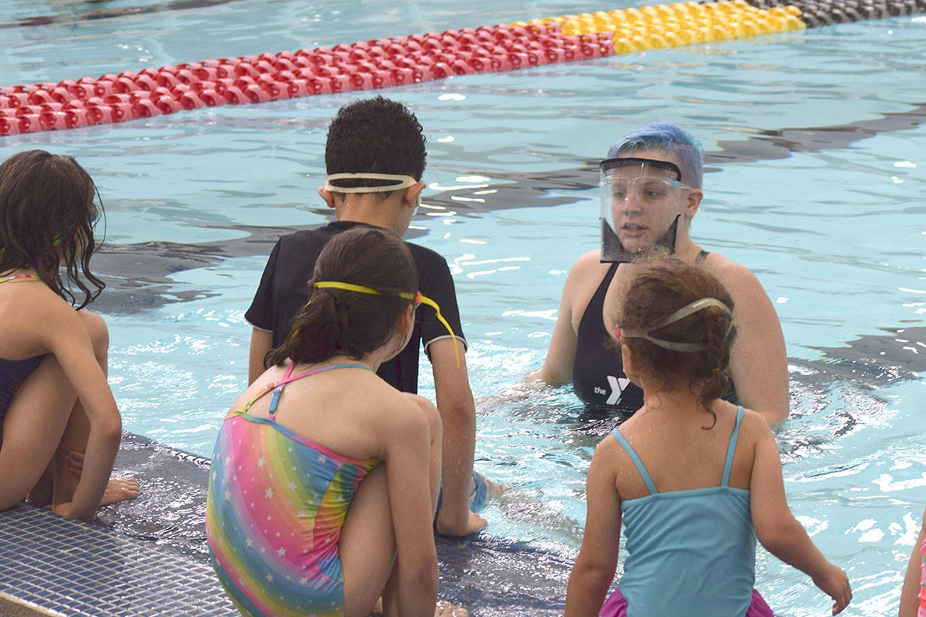 Kate Henninger, YMCA of Sequim Aquatics Director, teaches youngsters at the YMCA's Spring Break Swim Camp earlier this year. She leads a free Safety Around Water Camp for youths of ages 6-12 this June. (Photo courtesy of YMCA of Sequim)
