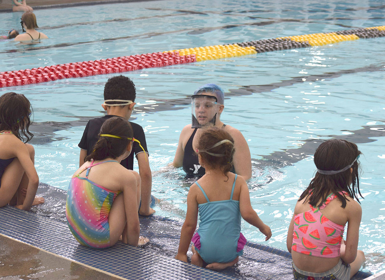 Kate Henninger, YMCA of Sequim Aquatics Director, teaches youngsters at the YMCAs Spring Break Swim Camp earlier this year. She leads a free Safety Around Water Camp for youths of ages 6-12 this June. (Photo courtesy of YMCA of Sequim)