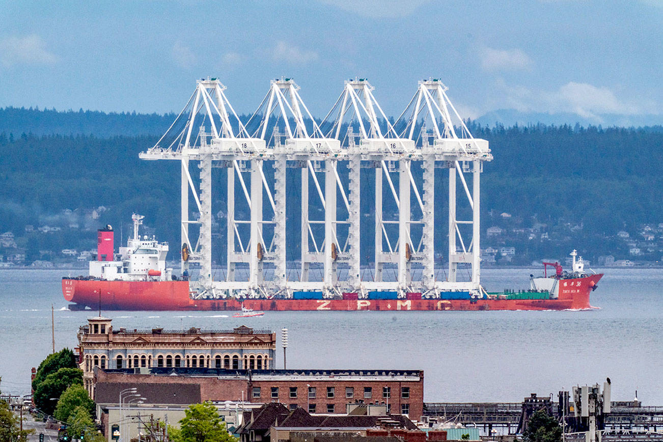 The heavy-lift vessel Zhen Hua, loaded with massive tower cranes and bound for the Port of Seattle, passes by the city of Port Townsend in the early Sunday morning. (Steve Mullensky/for Peninsula Daily News)