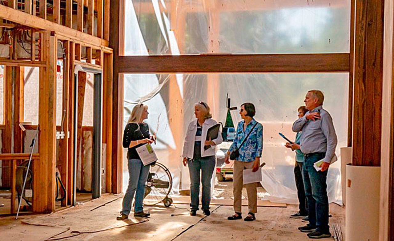 Rep. Steve Tharinger, right, views the new atrium at the Dungeness River Audubon Center. Pictured, from left, are: Annette Nesse, program manager for the Jamestown S’Klallam Tribe; Annette Hanson, “Inspire Wonder” capital campaign chair; capital campaign grant writer Lyn Muench; river center board member Laura Dubois, and Tharinger. (Photo by Margi Palmer)