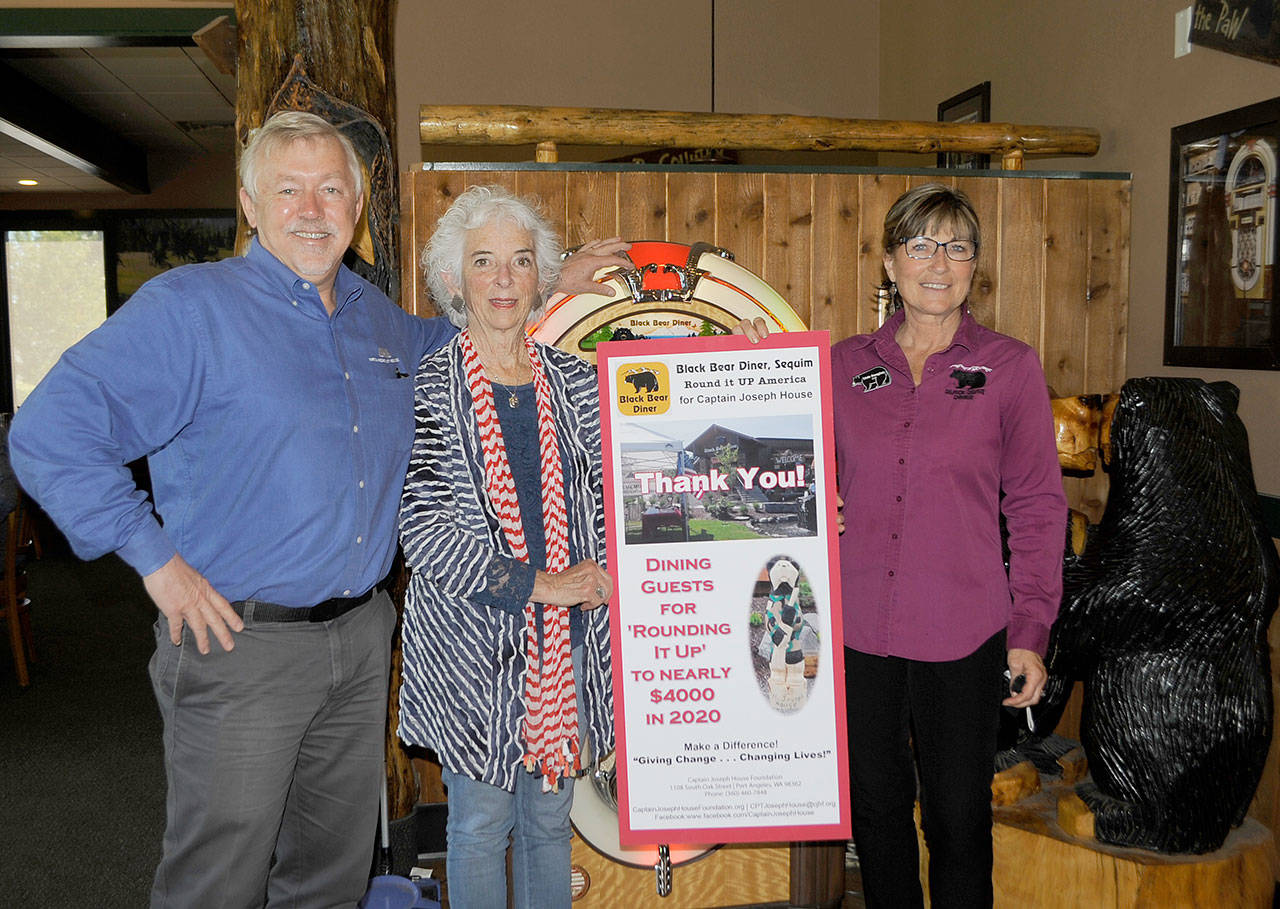 Over four years, Black Bear Diner customers have donated to the Captain Joseph House Foundation to support families of fallen soldiers. Last week, foundation executive director Betsy Reed Schultz shared a sign thanking the restaurant with owner Bret Wirta and manager Linda Donaghay accepting the sign. (Matthew Nash/Olympic Peninsula News Group)