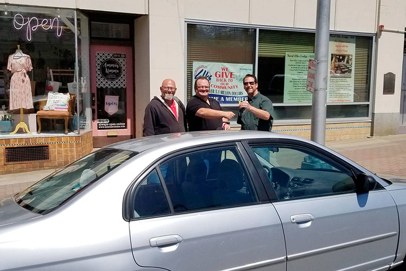 Sabaston Bushnell, left, looks on as Naval Elks Lodge Exalted Ruler Evan Boyd, far right. presents the keys to a Honda Civic to Ryan Bushnell. Bushnell, center, a service-related disabled veteran and a Port Angeles resident, has been commuting to his full-time job by bicycle for the past year. The car, which was donated to Naval Elks Lodge No. 353, was repaired by the automobile mechanics program at Peninsula College with parts donated by Simpson’s Towing and Salvage. Boyd also thanked Past Exalted Ruler Rob Gunn for taking care of the final touches on the car and coordinating the donation. 
--