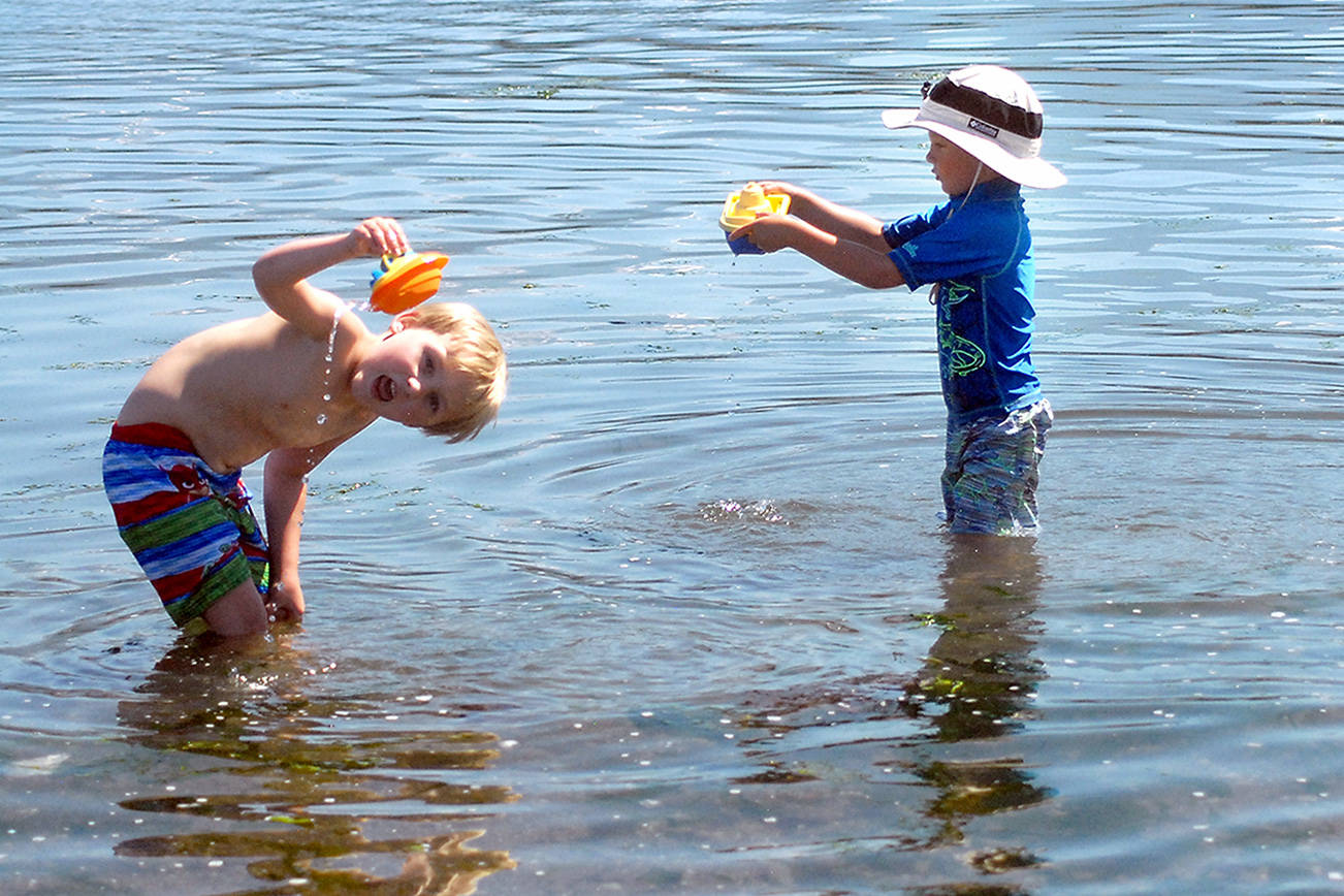Keith Thorpe/Peninsula Daily News
Xander Sivo, 6, left, and Matthew Taber, 4, both of Port Angeles, play in the water of Port Angeles Harbor at Ediz Hook in Port Angeles on Saturday, With temperatures creeping into the 90s across much of the North Olympic Peninsula, many people are seeking relief from the heat, which is expected to last at least through Monday.