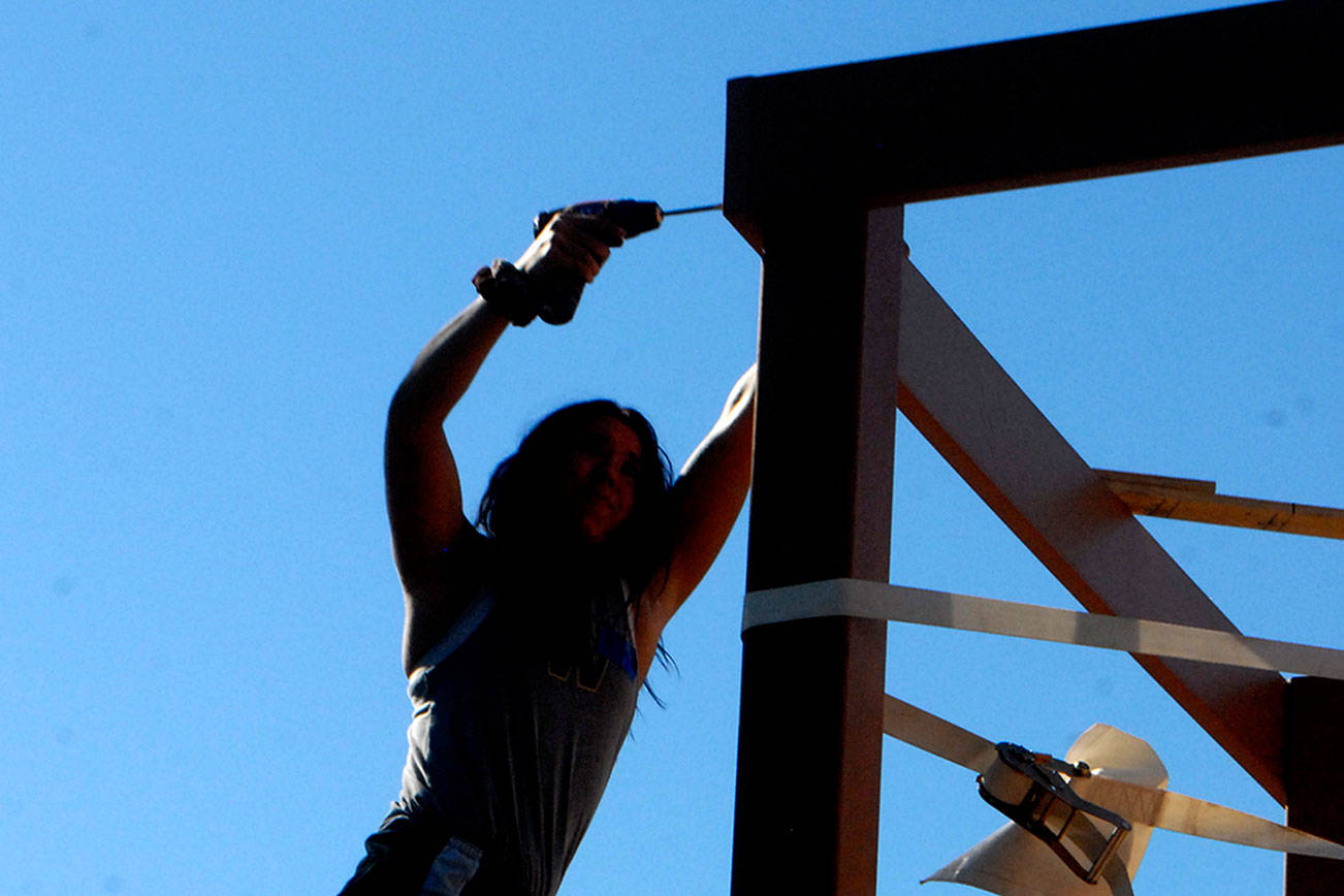 Keith Thorpe/Peninsula Daily News
Chynna Penird of Port Angeles uses a drill to drive screws into a support structure on rhe Generation II Dream Playground  at Erickson Playfield in Port Angeles on Saturday morning.