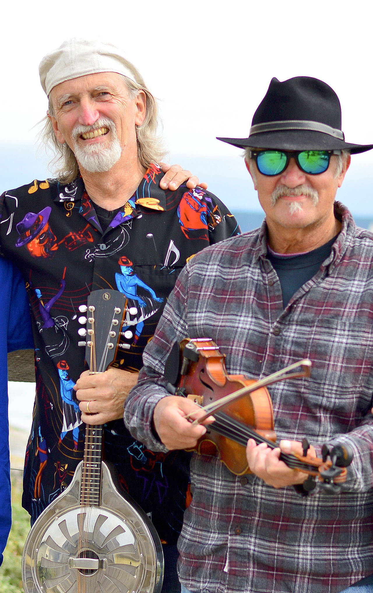 Multi-instrumentalist John Maxwell, left, and blues violinist Jon Parry will mix their music into the Red, White & the Blues event Sunday at the Old Alcohol Plant. (Diane Urbani de la Paz/Peninsula Daily News)