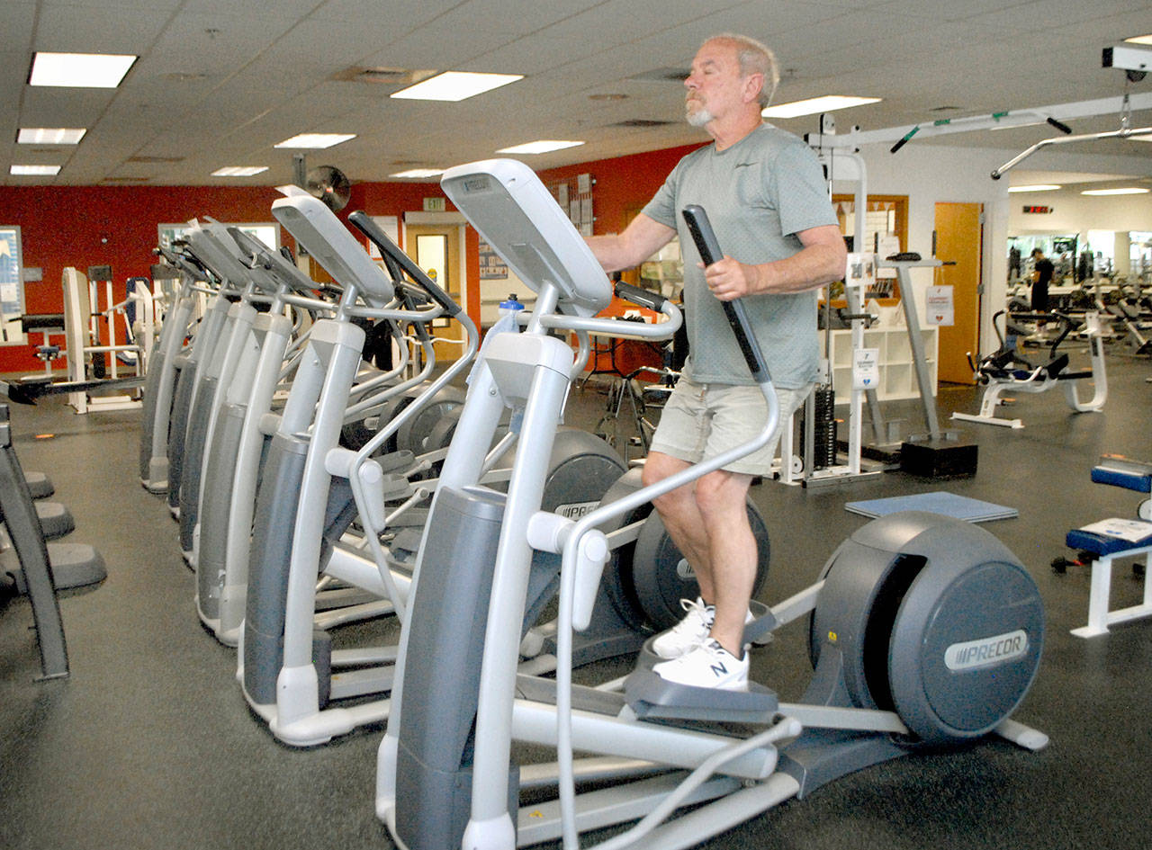 Mike Schefers of Port Angeles works out at the Olympic Peninsula YMCA in Port Angeles. (Keith Thorpe/Peninsula Daily News)