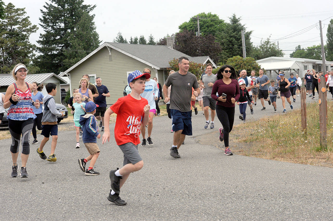 They were off running and walking in Forks during Saturday’s Fourth of July Fun Run presented by the Forks Community Hospital. The celebration peaks today with a Grand Parade and a host of other events. (Lonnie Archibald/for Peninsula Daily News)