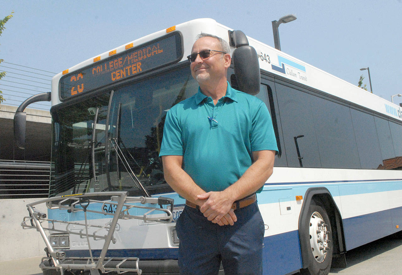 Clallam Transit General Manager Kevin Gallacci stands in front of a Route 20 bus. The route will see expanded service, including Peninsula College and Olympic Medical Center. (Keith Thorpe/Peninsula Daily News)
