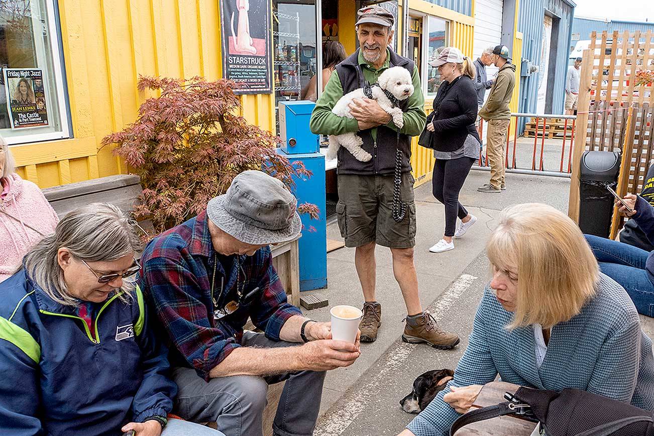 Tony Genovese, center, holding his dog Cleo, enjoys meeting his friends at Sunrise Coffee in Port Townsend on Monday morning. Genovese is a member of the Port Townsend New Friendships Meetup group and has been meeting for coffee and a walk every Monday for the past four years. “It’s wonderful to see the faces of my friends without masks once again,” he said. Seated, from left, are Betty Peterson-Wheeler, Norman Christie and Norma Bishop, all members of the group. (Steve Mullensky/For Peninsula Daily News)