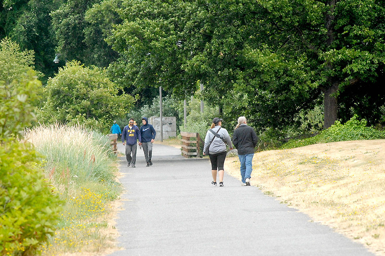 Pedestrians walk along a section of the Waterfront Trail east of downtown Port Angeles on Wednesday. (Keith Thorpe/Peninsula Daily News)