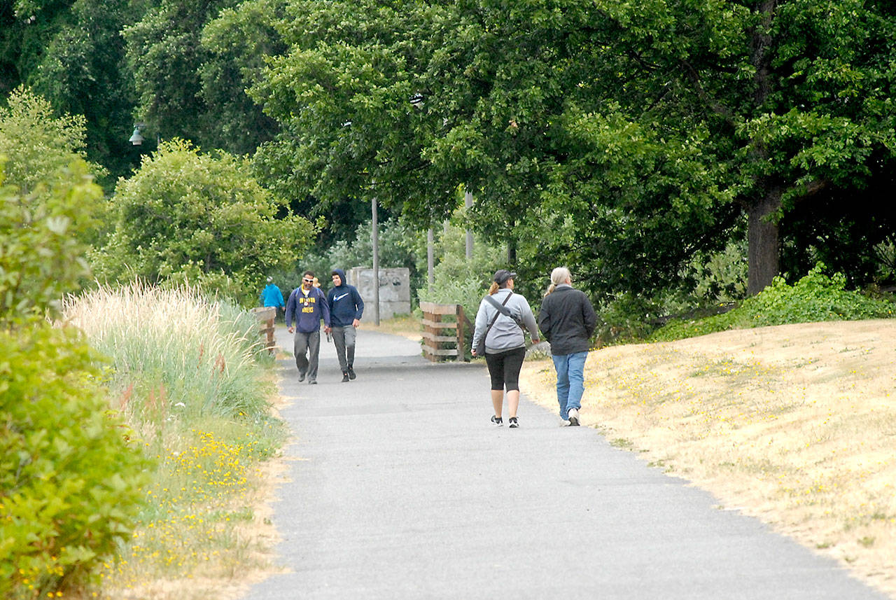 Pedestrians walk along a section of the Waterfront Trail east of downtown Port Angeles on Wednesday. (Keith Thorpe/Peninsula Daily News)