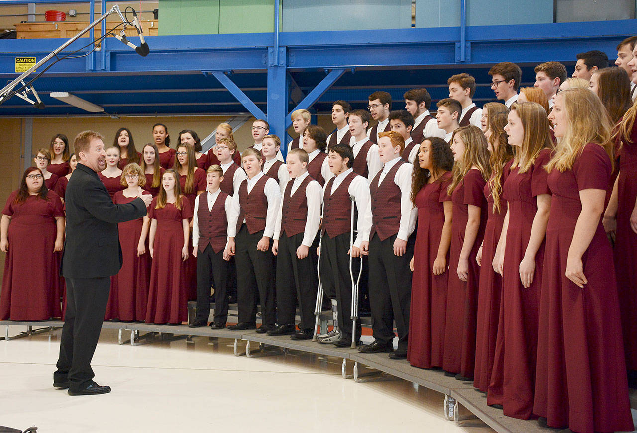 The Sequim High School Select Choir, directed by John Lorentzen, sings “The Star-Spangled Banner” in the hanger at the U.S. Coast Guard Air Station/Sector Field Office on Veterans Day in 2019. (Michael Dashiell/Olympic Peninsula News Group)