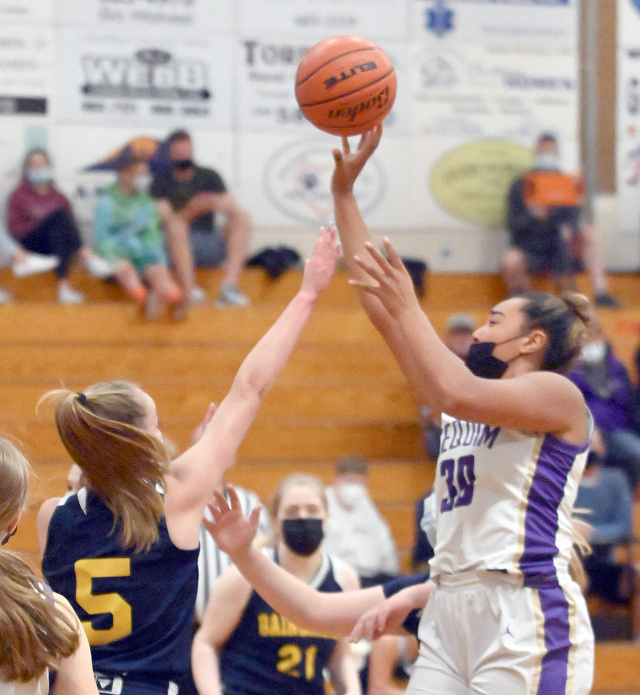 Sequim’s Jayla Julmist, right, shoots during an Olympic League Tournament win over Bainbridge last month. Julmist has signed a letter of intent to play basketball for her parents’ alma mater, The Master’s University in California. (Michael Dashiell/Olympic Peninsula News Group)