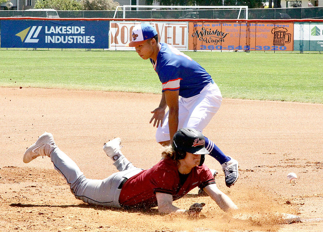 Jeremy Vierra of the Redmond Dudes is safe on a throw to first base Sunday. Playing first base for the Lefties is Nathan Chong of Saint Mary’s College of California. (Dave Logan/For Peninsula Daily News)