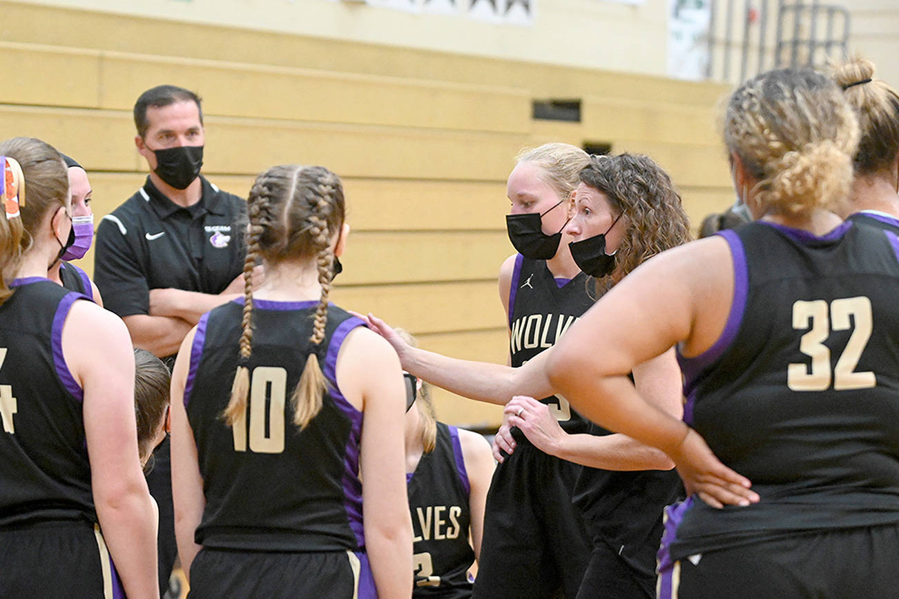 Michael Dashiell/Olympic News Group
Sequim girls basketball head coach Linsay Rapelje, at right, has stepped down from the position after leading the team to a state tournament berth and a 43-17 record over the last three seasons.