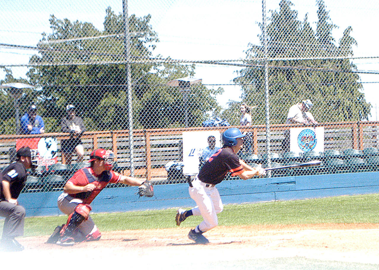 Nick Oakley of the Port Angeles Lefties bunts for a first-inning single against the Walla Walla Sweets on Sunday. Catching for Walla Walla is Colin Watterau. (Pierre LaBossiere/Peninsula Daily News)