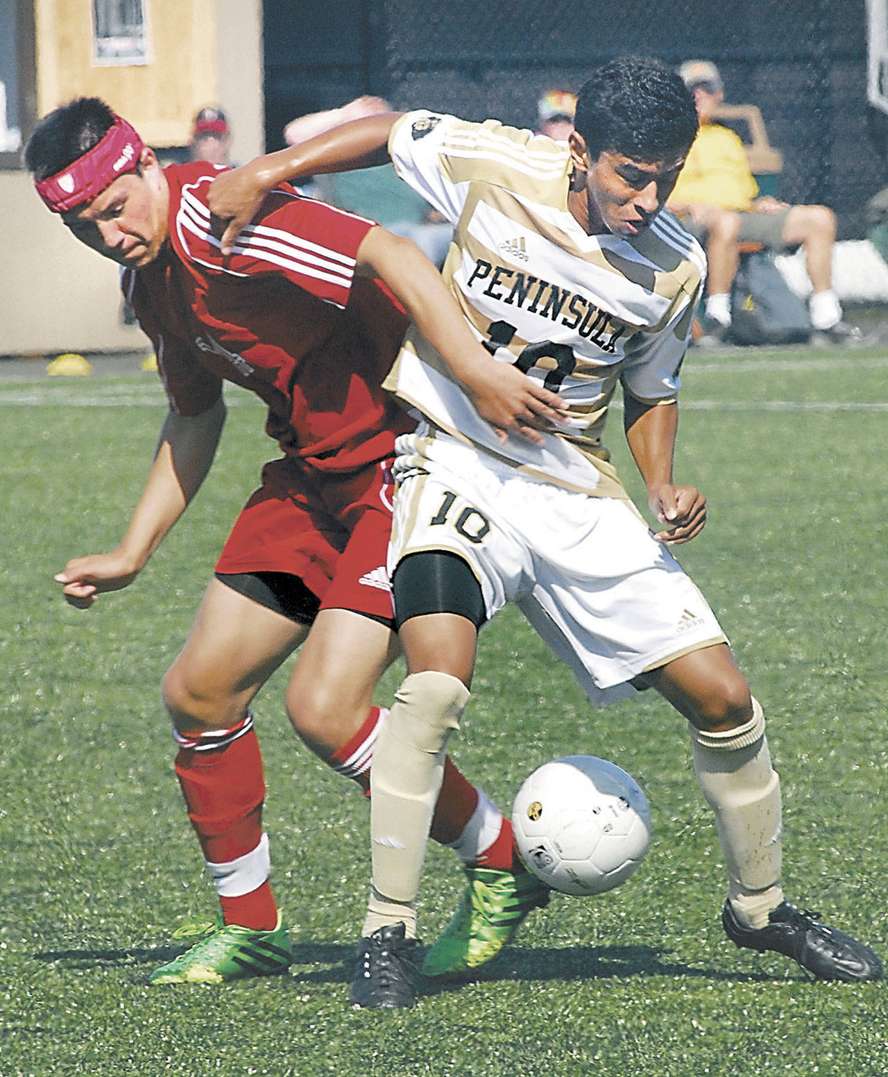 Southwestern Oregon’s Zachary Barker, left, battles with Peninsula’s Erick Urzua in 2013 in Port Angeles. The NWAC-champion 2012 and 2013 Pirate men’s and women’s soccer teams will be inducted into the Pirates Hall of Fame along with longtime basketball scorekeeper Bill Peterson on Sept. 25. (Keith Thorpe/Peninsula Daily News)