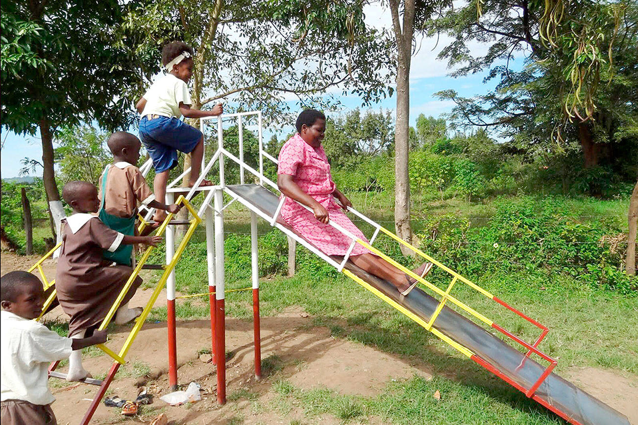 House mother and teacher Mama Ruth tries out the new slide at the Star of Hope Centre in Kenya. photo courtesy of Star of Hope Centre