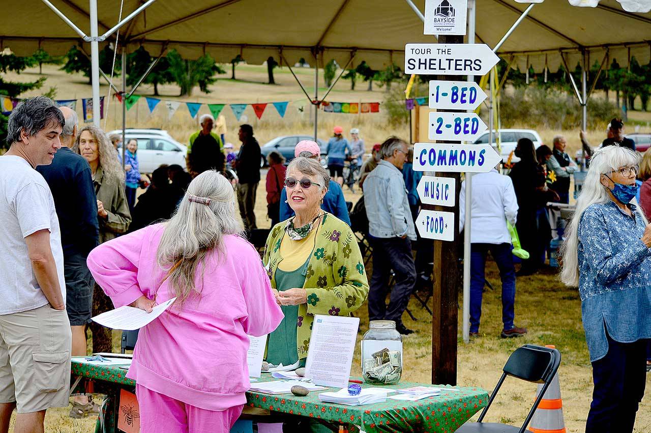 Volunteer coordinator Debbi Steele, center, welcomes visitors to Saturdays Community Build Project open house in Port Townsend. (Diane Urbani de la Paz/Peninsula Daily News)