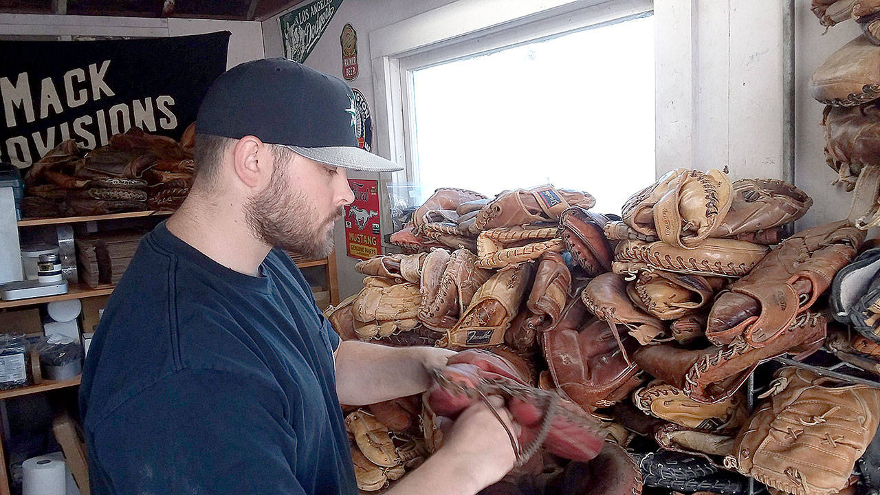 KC Mack of Port Angeles has at least 500 old baseball gloves in his work shed for his business of turning gloves into wallets and other leather items. (Pierre LaBossiere/Peninsula Daily News)