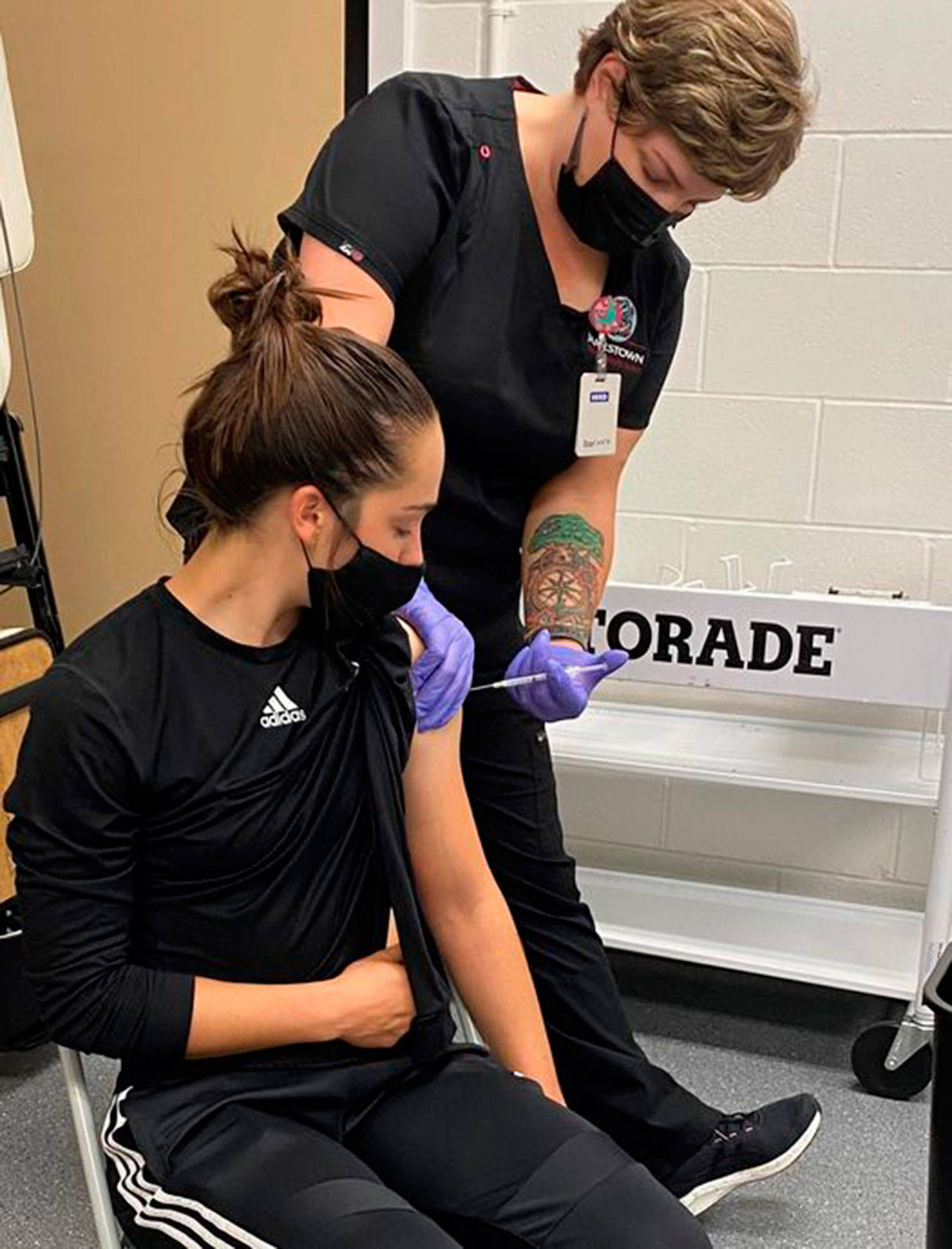 Kascia Muscutt, a soccer player and Associated Student Body president at Peninsula College, gets a COVID vaccination shot from a Jamestown Health Clinic staffer. (Photo courtesy of Peninsula College)