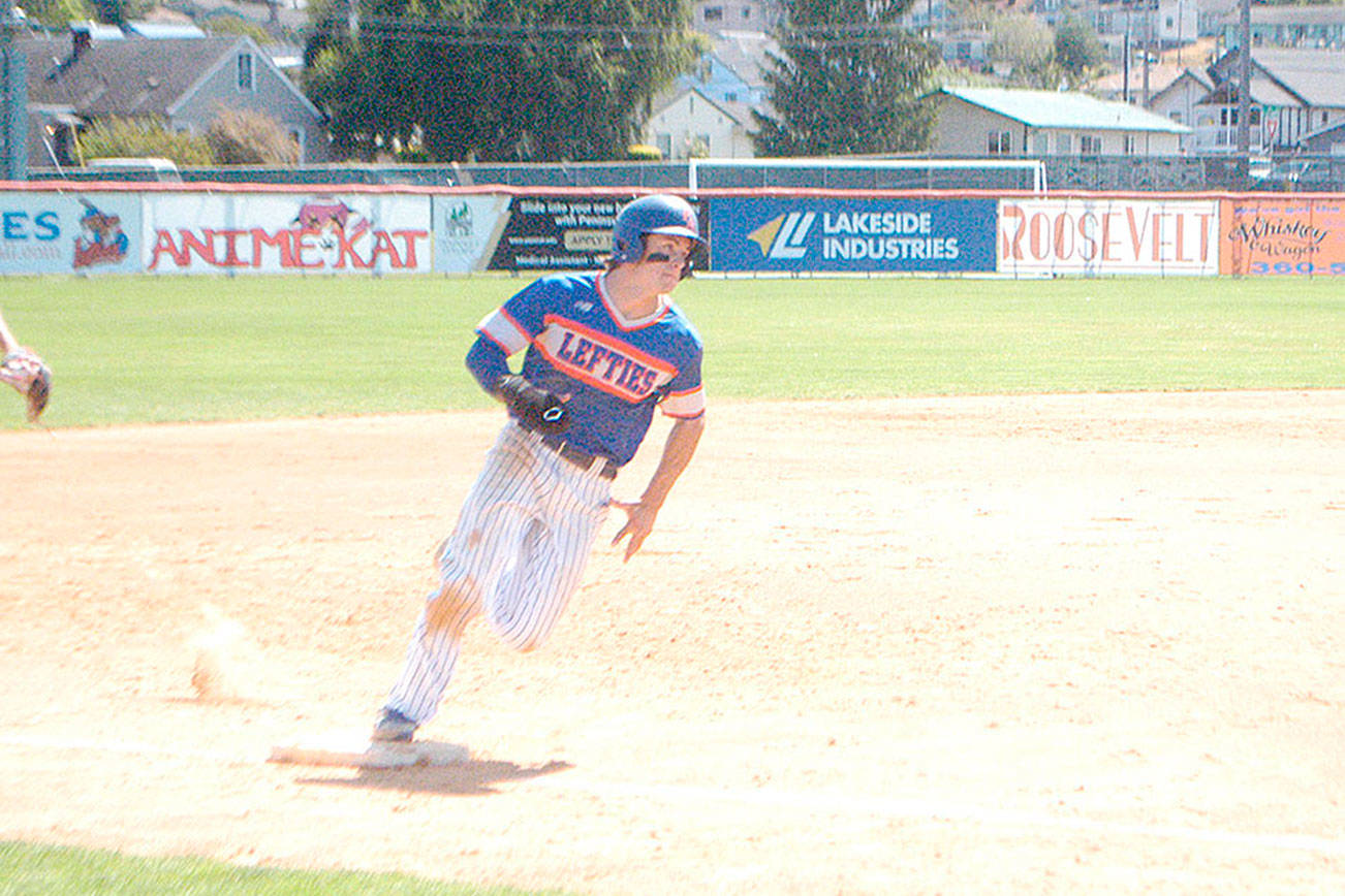 The Lefties' Nick Oakley rounds third base Sunday at Civic Field on his way to score on a double by Nathan Chong. (Pierre LaBossiere/Peninsula Daily News)