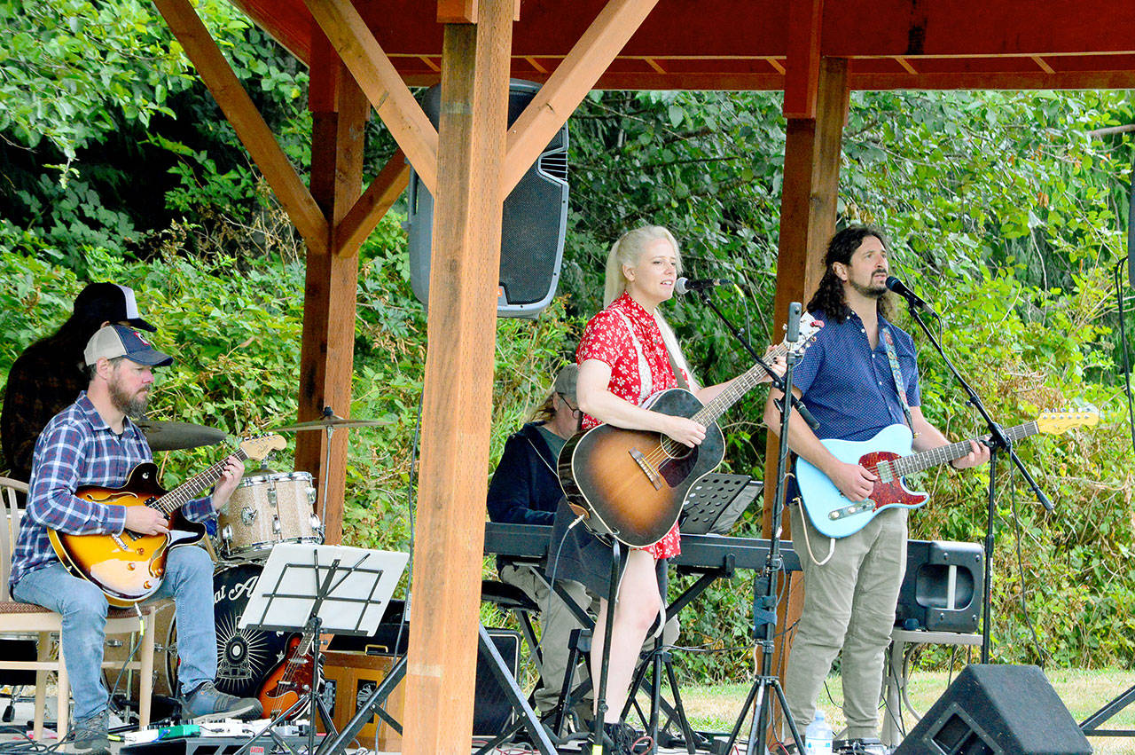Amid the Saturday afternoon drizzle, the Seattle band Great American Trainwreck brings country and rock to the Laurel B. Johnson Community Center in Coyle. The Concerts in the Woods series (<a href="http://www.coyleconcerts.com" target="_blank">coyleconcerts.com</a>) is presenting free outdoor shows this summer. (Diane Urbani de la Paz/Peninsula Daily News)