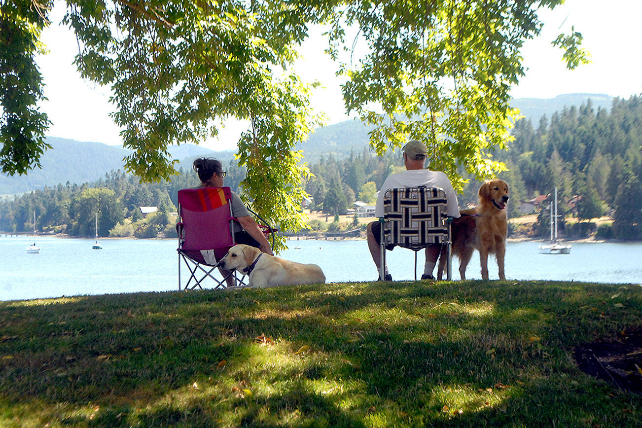Keith Thorpe/Peninsula Daily News
Laurie and Ford Rathbun of Bonney Lake, along with dogs Chevy and Jack, take in the view of Sequim Bay from John Wayne Marina near Sequim. The couple and their pets were staying in a nearby RV park and decided to spend part of their day lounging by the bay.
