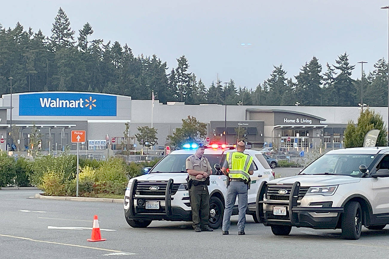 Law enforcement officers block the entrances to the Walmart Supercenter in Port Angeles on Friday evening after a bomb threat was received. (Scott Gardinier/Peninsula Daily News)