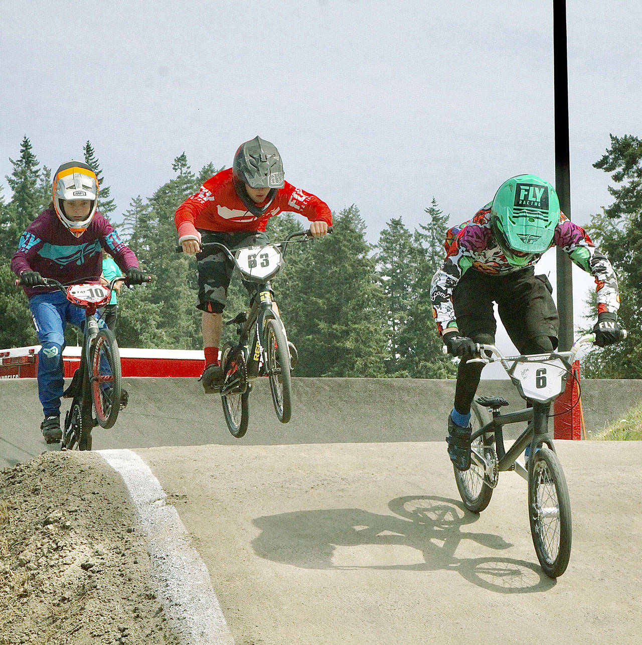 Lincoln Park BMX Track was the center for BMX racing in Western Washington over the weekend as the park hosted state-qualifying races for the state championships in Spokane next month and Gold Cup qualifiers for a five-state regional championship in Richland in September. In the 14 Expert class are No. 10 Josiah Ringstad of Port Orchard, No. 63 Cash Coleman of Port Angeles and, in the lead, No. 6 Jackson Beal of Port Townsend. (Dave Logan/for Peninsula Daily News)