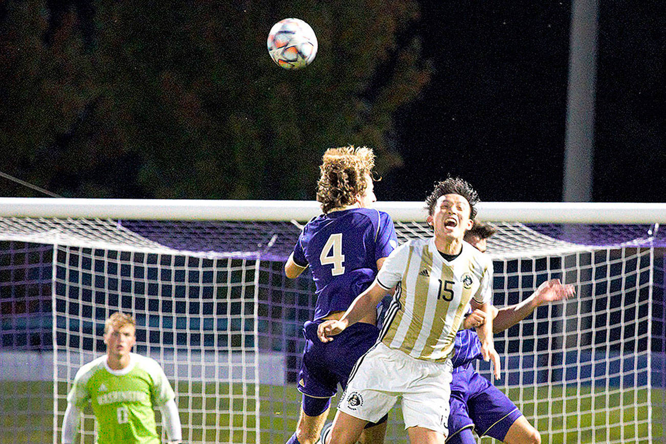 Peninsula College's Chunghwan Lee (15), goes up for a header against the University of Washington's Ryan Sailor (4) in a scrimmage played Sunday at the University of Washington. (Rick Ross/Peninsula College)