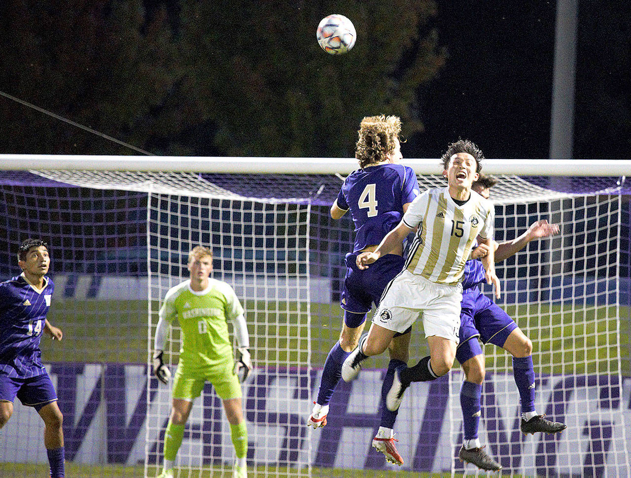 Rick Ross/Peninsula College Peninsula College’s Chunghwan Lee (15), goes up for a header against the University of Washington’s Ryan Sailor (4) in a scrimmage played Sunday at the University of Washington.