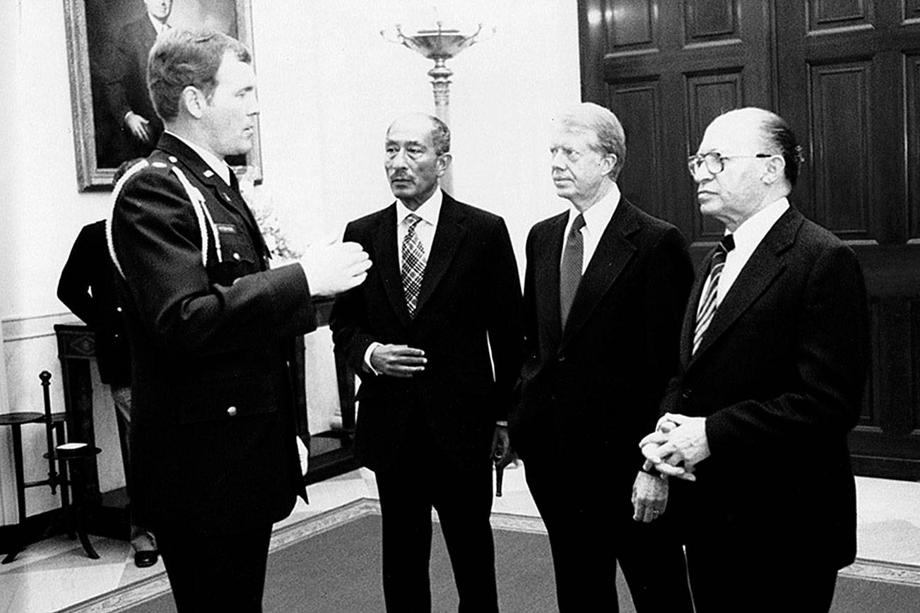 Port Angeles High School graduate Bob Peterson, left, meets with Egypt's Anwar Sadat, U.S. President Jimmy Carter and Isreal's Menachem Begin in the 1970s. After starring as a Roughriders football player, Peterson joined the U.S. Air Force and will be inducted into the Roughrider Hall of Fame on Saturday.