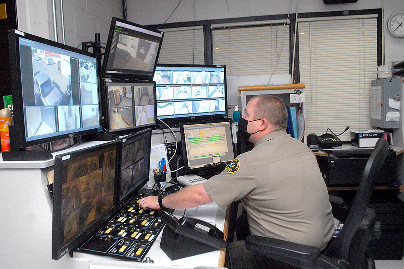 Deputy Rick Bray watches surveillance monitors from the control room at the Clallam County Jail on Wednesday in Port Angeles. (Keith Thorpe/Peninsula Daily News)