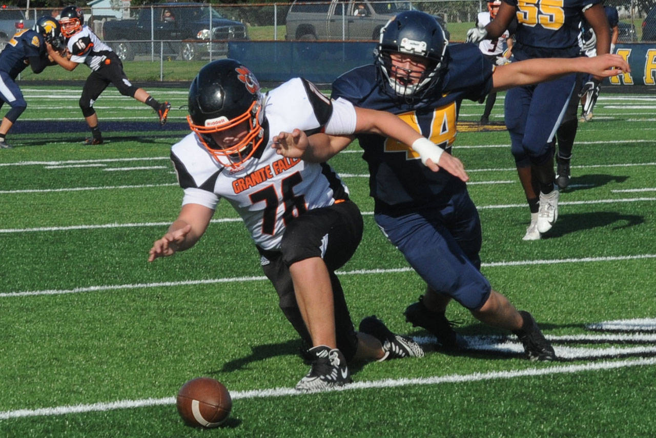 Forks’ Matthew Wallerstedt, right, tracks down the loose football after blocking a punt during a 2019 game against Granite Falls. Wallerstedt is expected to start at guard and defensive end for the Spartans this season. (Lonnie Archibald/for Peninsula Daily News)