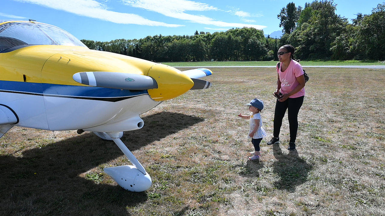 Kendall Huff and nearly-2-year-old Kenna Huff of Snohomish get an up-close look at an RV-9A homebulit aircraft at the eighth Olympic Peninsula Air Affaire and Fly-In on Saturday afternoon in Sequim. This year’s show, reduced to a one-day fest, featured helicopter and airplane rides, dozens of airplanes, classic cars and remote control airplane demonstrations at the Sequim Valley Airport. Olympic Pen on Aug. 28. Michael Dashiell/Olympic Peninsula News Group
Kendall Huff and nearly-2-year-old Kenna Huff of Snohomish get an up-close look at an RV-9A homebulit aircraft at the eighth Olympic Peninsula Air Affaire and Fly-In on Saturday afternoon in Sequim. This year’s show, reduced to a one-day fest, featured helicopter and airplane rides, dozens of airplanes, classic cars and remote control airplane demonstrations at the Sequim Valley Airport. (Michael Dashiell/Olympic Peninsula News Group)