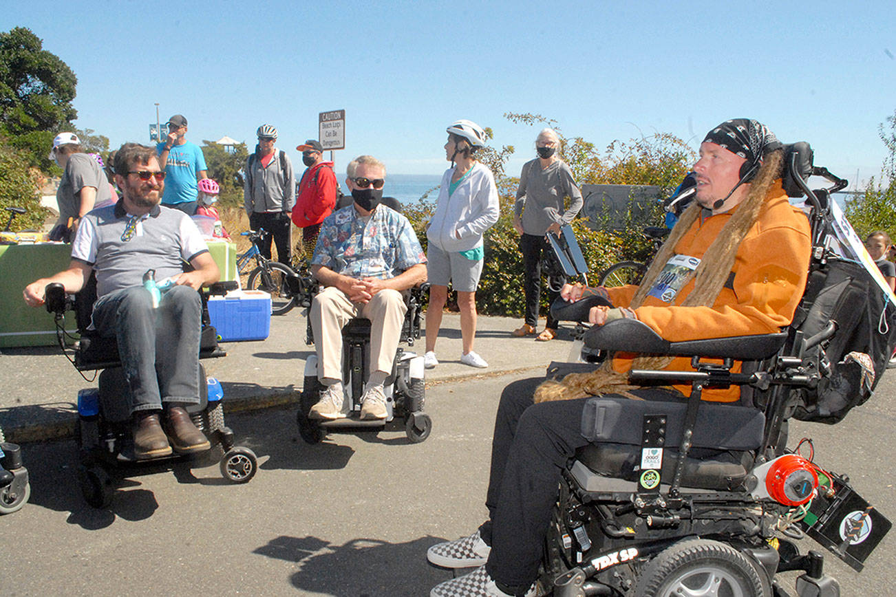 Ian Mackay, right, briefs motorized wheelchair riders, from left, Jefferson County Commissioner Greg Brotherton and Clallam County Commissioner Randy Johnson as they prepare to participate in a leg of Ian’s Ride on Saturday at Port Angeles City Pier. (Keith Thorpe/Peninsula Daily News)