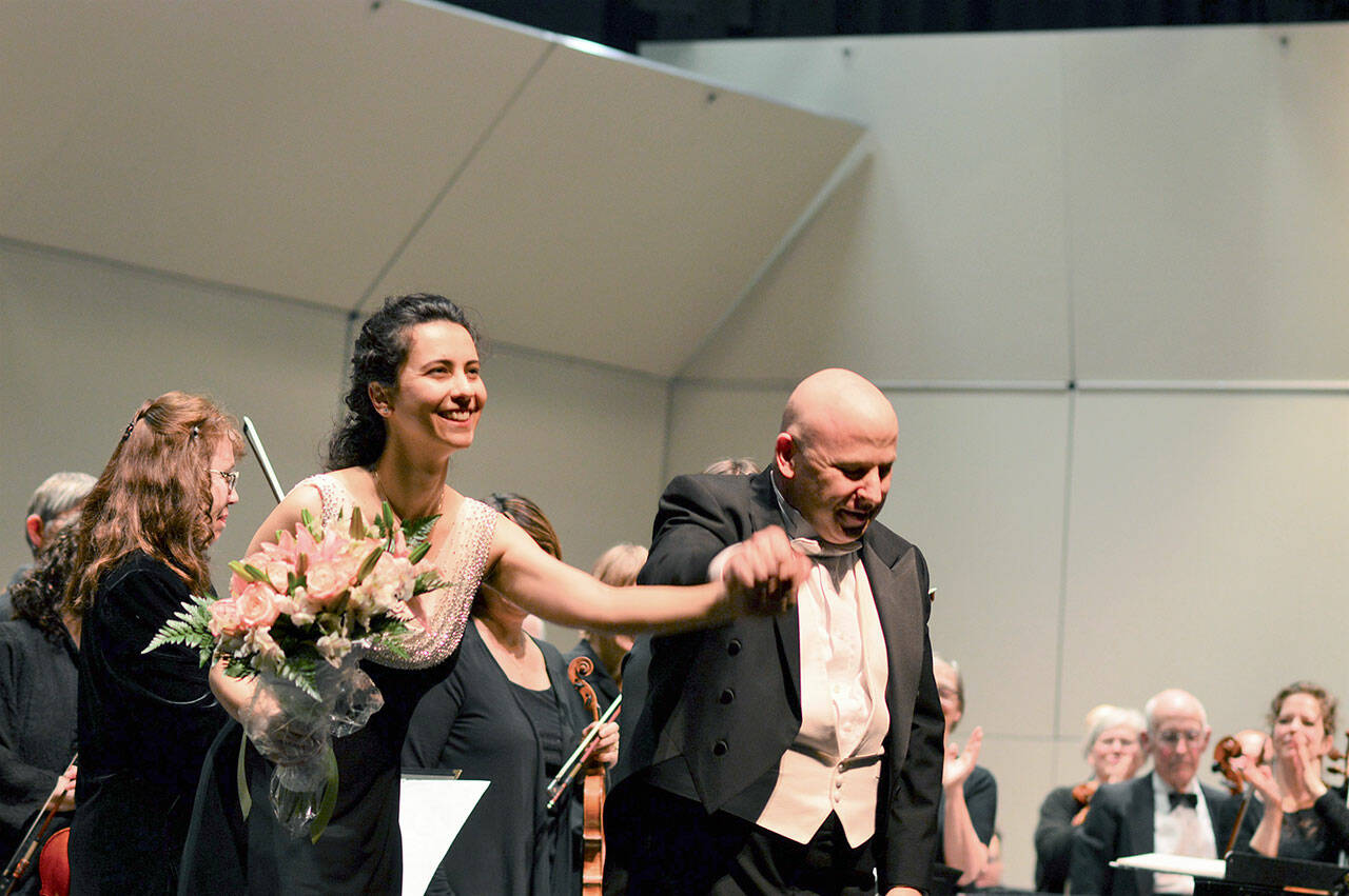 Anna Petrova, pictured taking her bow with Port Angeles Symphony conductor Jonathan Pasternack in 2017, is slated to return as guest pianist this November. (Diane Urbani de la Paz/Peninsula Daily News)
