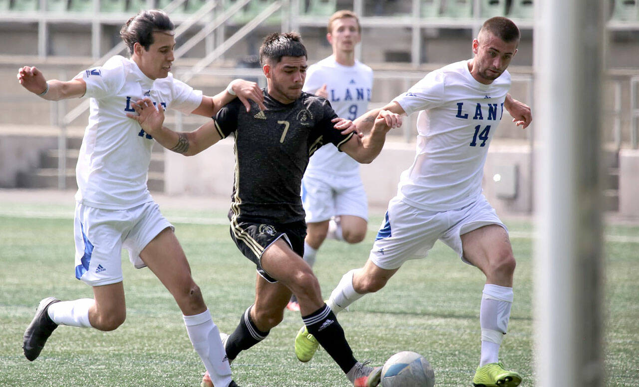 Peninsula’s Jonathon De Motta, center, dribbles between two Lane defenders during the Pirates’ 2-0 season-opening win last week. The Pirate men host Wenatchee Valley at 4 p.m. Sunday in their home opener. Peninsula’s women host a free scrimmage tonight at 7 p.m. (Rick Ross/Peninsula College Athletics)