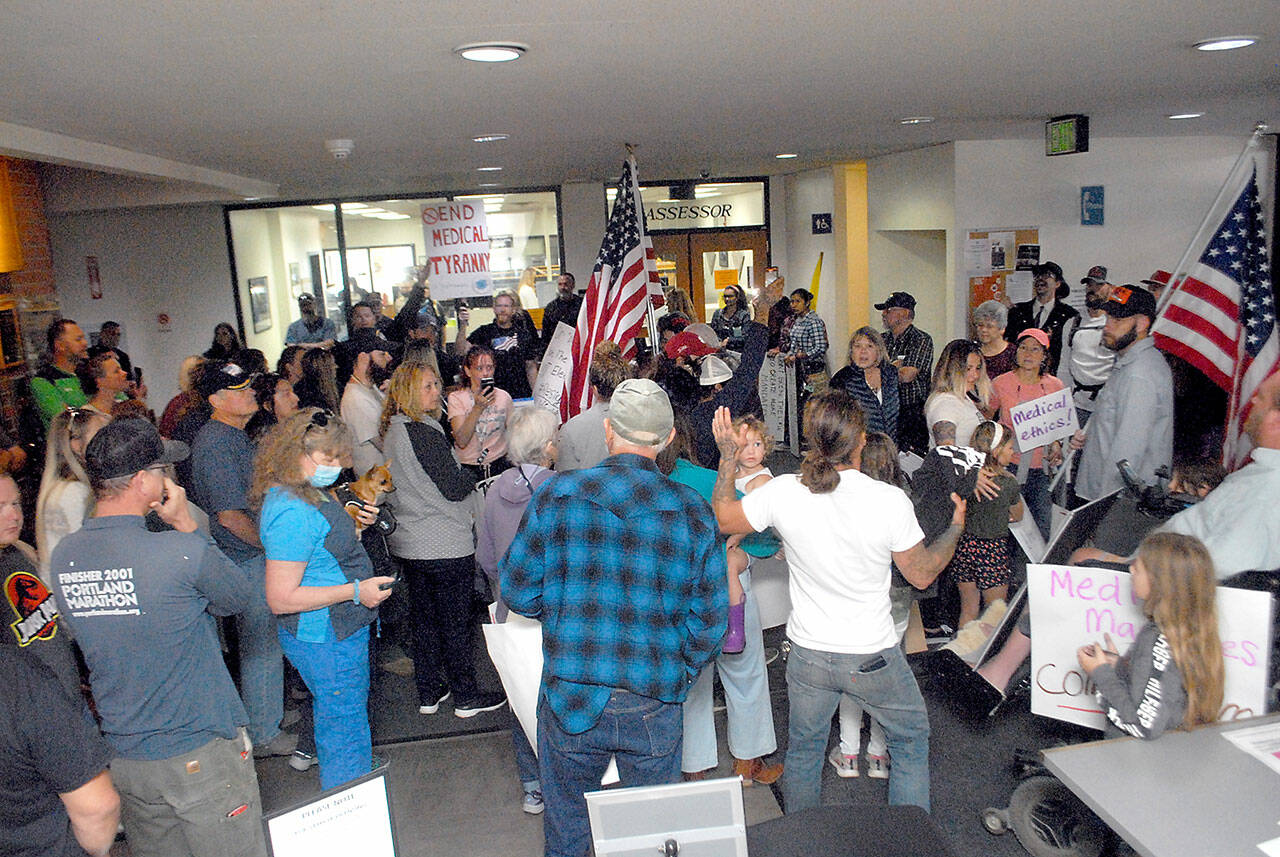Protesters gather in the lobby of the Clallam County Courthouse on Friday. (