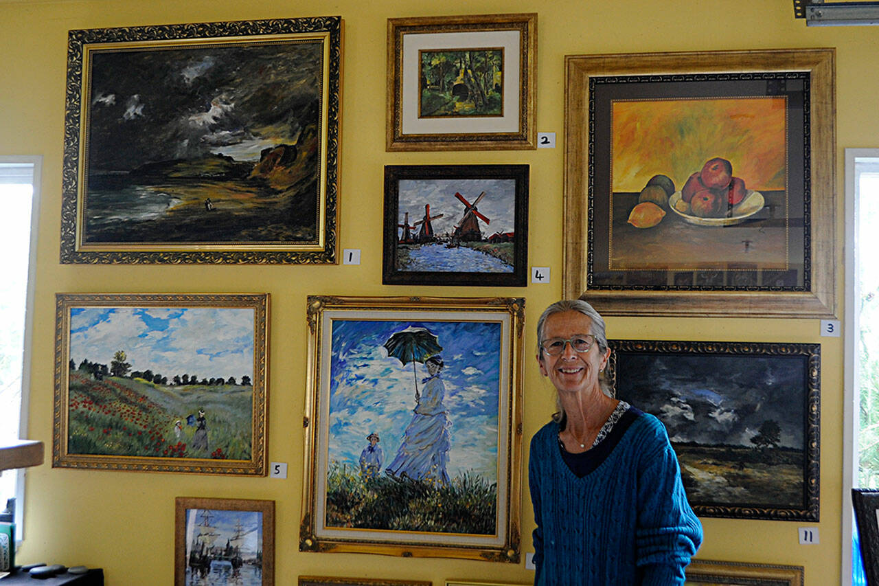 Carrie Rodlend plans to auction off more than 30 reimagined classic paintings, such as Claude Monet’s “Woman with a Parasol — Madame Monet and Her Son” on Saturday from her home studio in Dungeness. She’s worked more than a year beside her students on reimagining classic paintings to teach new techniques. (Matthew Nash/Olympic Peninsula News Group)