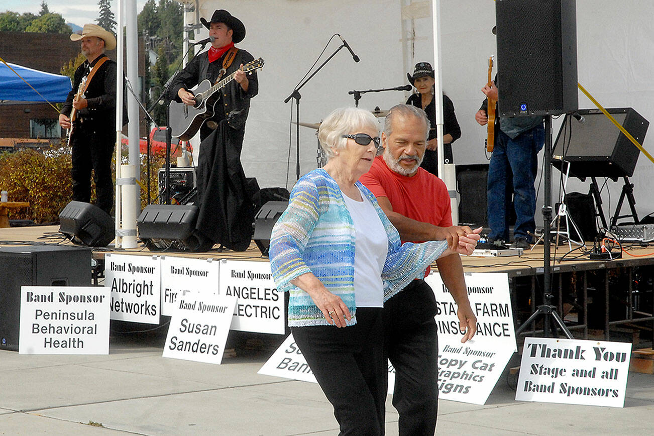 Keith Thorpe/Peninsula Daily News
Loretta Bilow of Sequim, left, and Angel Ortiz of Port Angeles dance to the music of the Buck Ellard Band during Saturday's Jammin' in the Park at Pebble Beach Park in Port Angeles. The event, hosted by Nor’Wester Rotary and Koenig Suburu, featured music, food, children's activities and a car show.