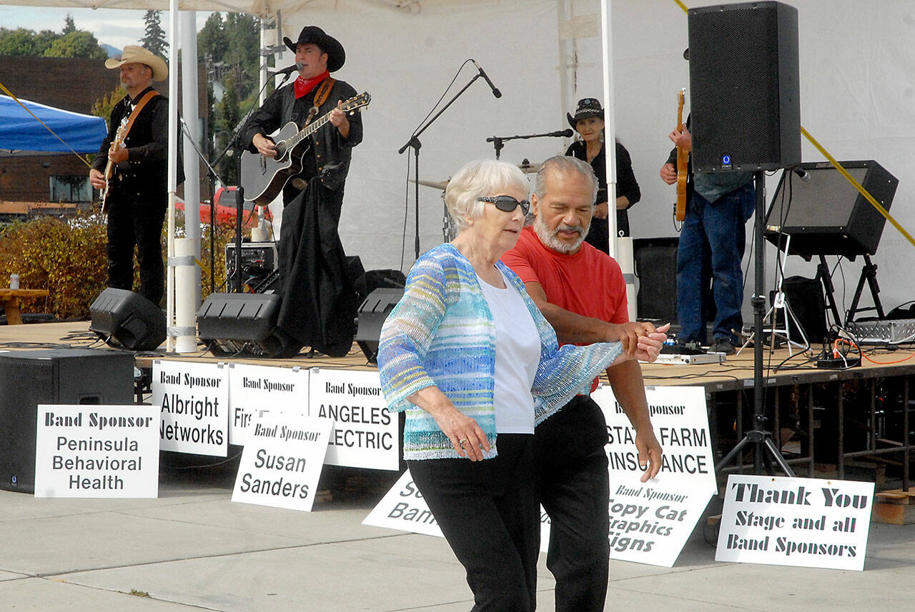 Loretta Bilow of Sequim, left, and Angel Ortiz of Port Angeles dance to the music of the Buck Ellard Band during Saturday’s Jammin’ in the Park at Pebble Beach Park in Port Angeles. The event, hosted by Nor’Wester Rotary and Koenig Suburu, featured music, food, children’s activities and a car show. (Keith Thorpe/Peninsula Daily News)