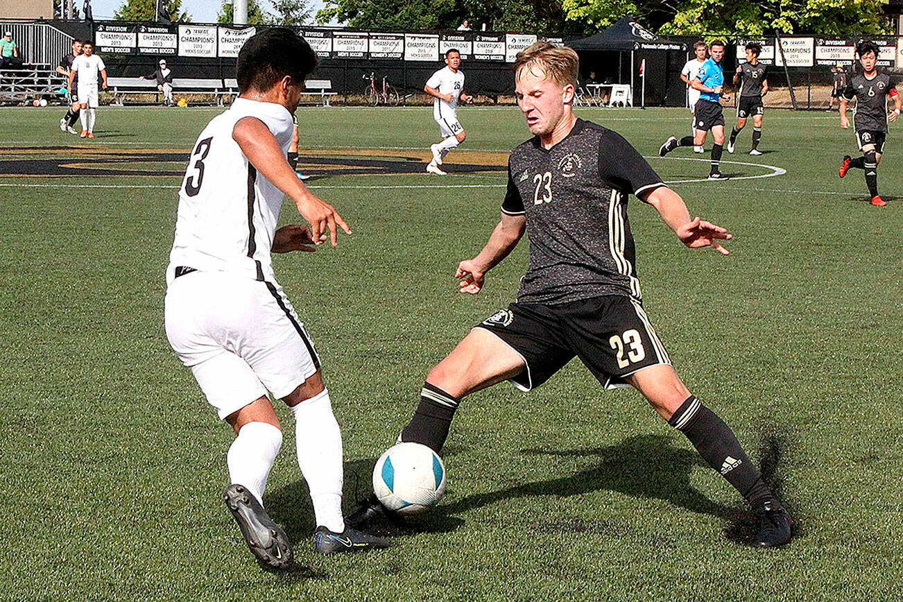 Dave Logan/for Peninsula Daily News
Peninsula College's Tim Deser (23) fights for the ball with Wenatchee Valley's Sebastian Aviles on Sunday afternoon at Wally Sigmar Field. The Pirates won 3-0 behind three goals in the second half.