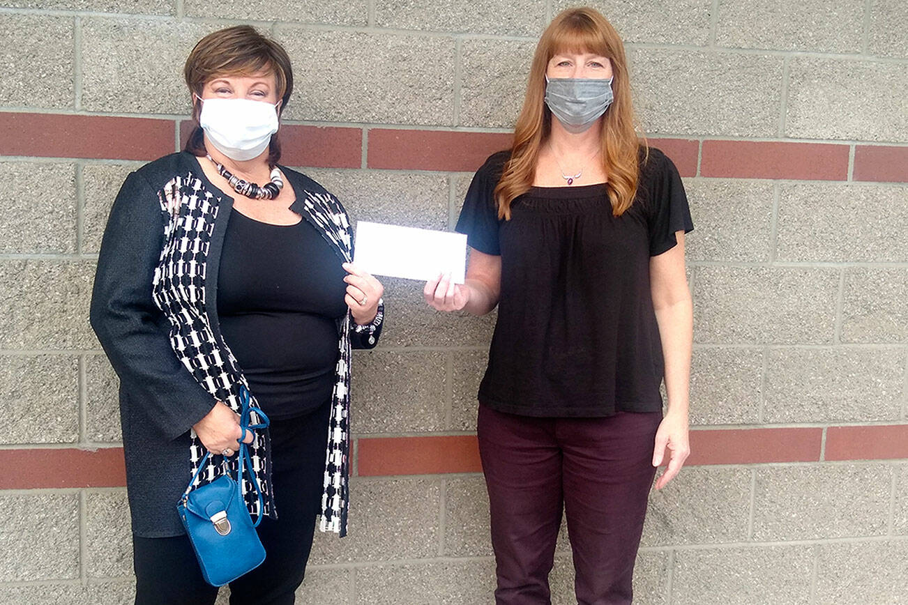 LuAnne Hinkle, left, of the Olympic Peninsula Humane Society, receives a check from Ginger Rushton of the home health department at Jim’s Pharmacy in Port Angeles. Staff and customers at the pharmacy raised more than $950 to support the humane society, the July recipient of Jim’s Cares Monthly Charity. The funds are raised through monetary donations, used book sales, donated employee casual days and a percentage of over-the-counter sales.