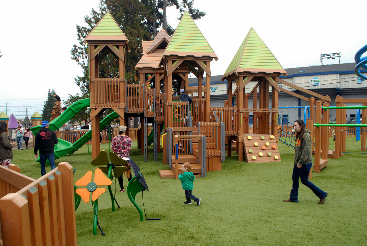 Children and parents roam through the Generation II Dream Playground at Erickson Playfield in Port Angeles. (Keith Thorpe/Peninsula Daily News)