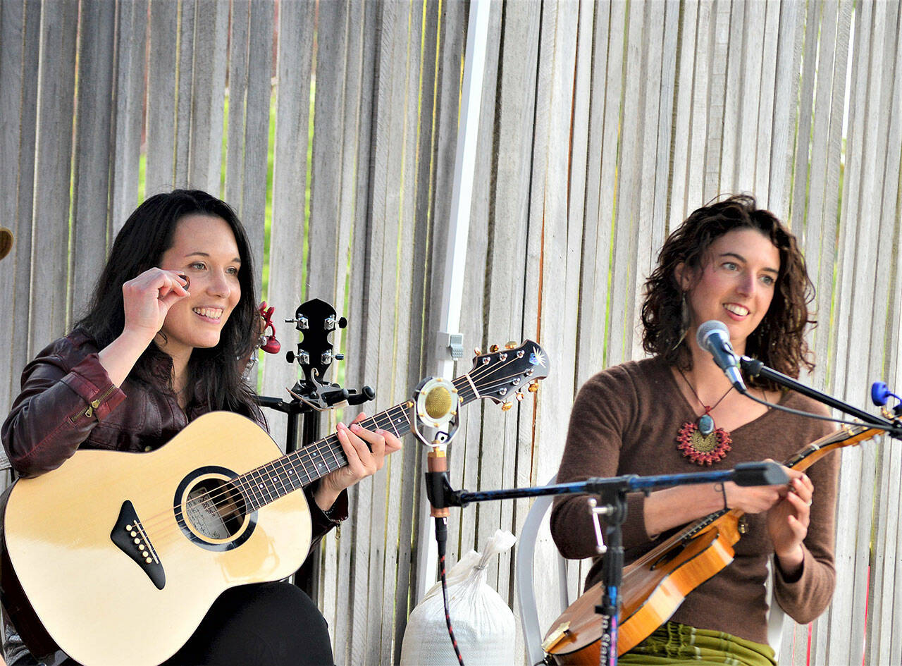 Micaela Kingslight, left, and Samara Jade are two-thirds of Three Wheels Turning, pictured during their May gig at the Keg & I in Chimacum. The trio, which also includes Aimée Ringle, will play from 6 p.m. to 8 p.m. this evening at Finnriver Farm & Cidery in Chimacum. (Diane Urbani de la Paz/Peninsula Daily News)